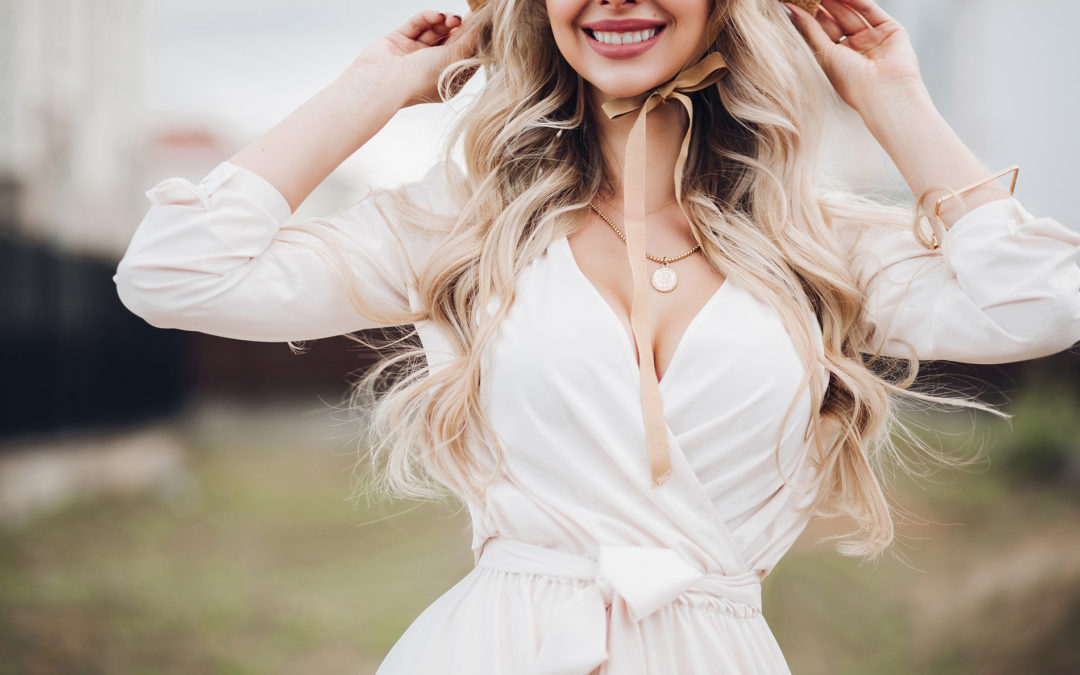 Gorgeous Blonde Woman With Long Wavy Hair Wearing Hat With Bows Showing Some Cleavage
