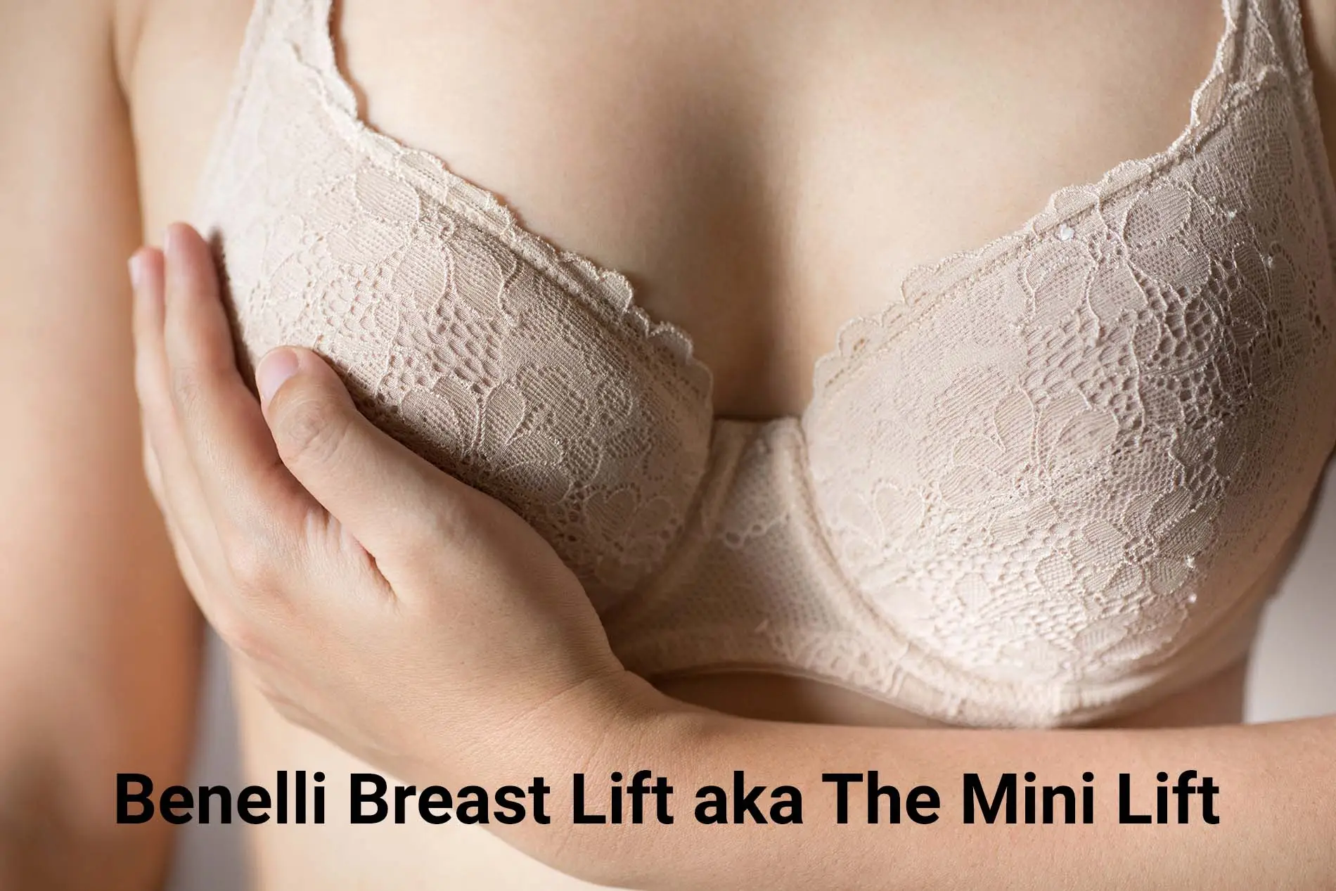 Woman in bra holding up one breast to replicate the affects of a Benelli Breast Lift.