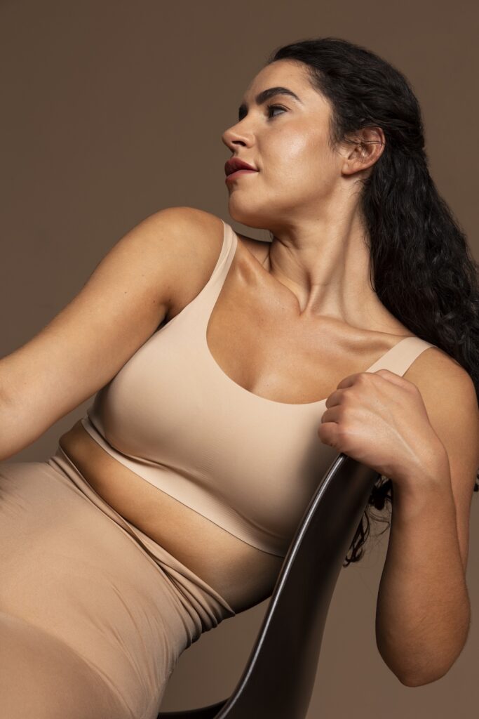 Woman considering breast lift procedure with capizzi md